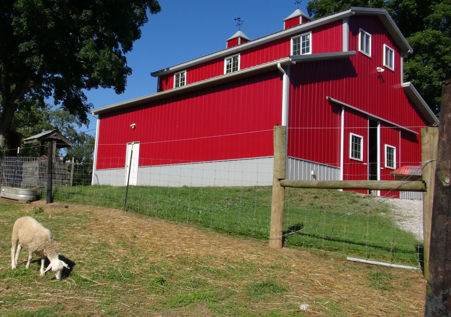 Red agricultural barn with cupolas