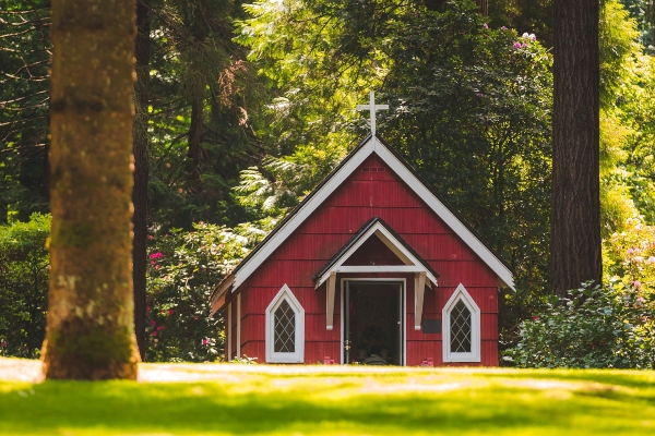 A church set into a forest location like this benefits from a metal roof to protect those worshiping inside.