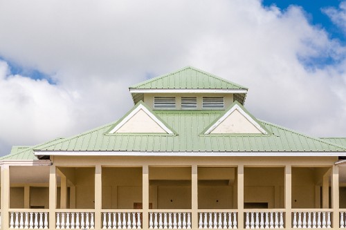 A home has a green metal roof.